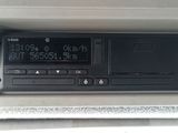 a radio in the center of a car with a clock on it