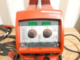 a red and black machine on a wooden table