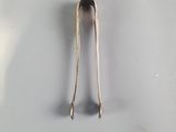 a silver spoon and a spoon rest on a white surface