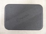 a close up of a black rubber mouse pad on a table