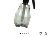 an image of a bottle of water with a spray gun on it
