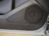 a close up of a car door with a speaker in it