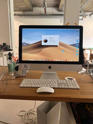 a computer on a desk with a keyboard and mouse
