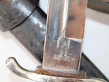 a close up of a knife with a handle on it