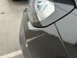 a close up of a car ' s headlight on a parking lot