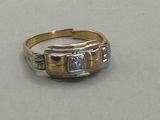 an image of a gold and diamond ring on a table