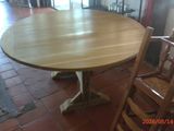 a table and chairs in a room with a brick floor