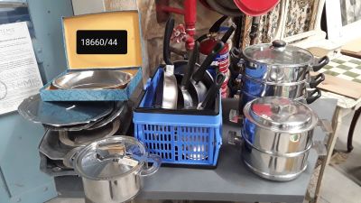 many pots and pans on a table in the kitchen