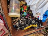 a box full of legos and other toys on the floor