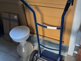 un diable bleu avec des toilettes en arrière-plan