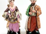 pair of figurines of a man and a woman dressed in traditional clothing