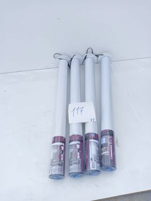 four white candles are sitting on top of a white table