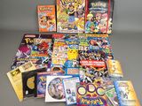 a lot of pokemon books and dvds on the table