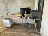 a desk with two computers and a printer on it