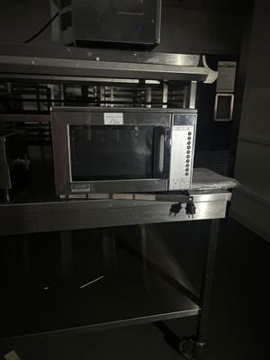 a microwave sitting on top of a table in a room