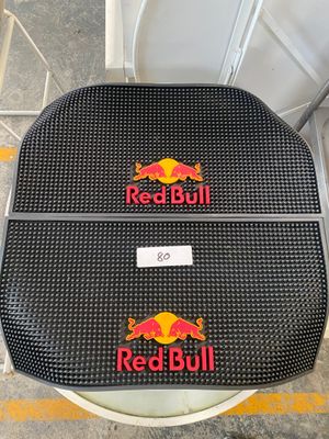 a pair of red bull seat covers on a toilet