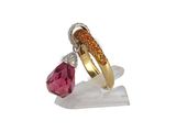 yellow gold ring with a pink diamond and a yellow gold ring with a pink diamond