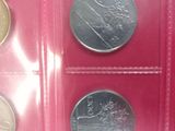 three different types of coins in a red case on a table