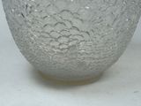 a close up of a glass bowl on a white surface