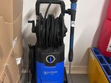 a blue and black vacuum cleaner on the floor next to boxes