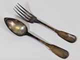 two spoons and a fork on a white surface