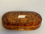 an old wooden box sitting on top of a white table