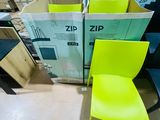a yellow chair sitting in front of a pile of boxes