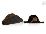 two hats that are sitting side by side on a white surface