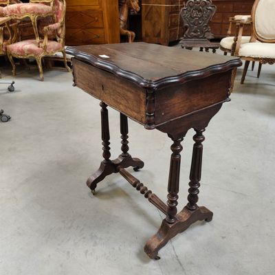 a small table with a wooden top in a room