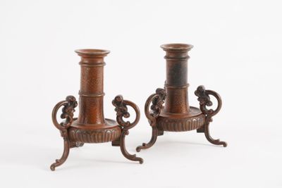 two brown vases sitting on top of each other on a white surface
