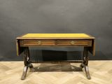 an antique writing table with two drawers and a yellow top