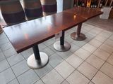 a table and chairs in a room with tile flooring