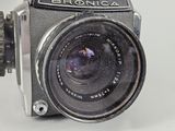 a close up of an old camera with a lens on it