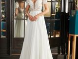 a woman in a wedding dress standing in front of a mirror