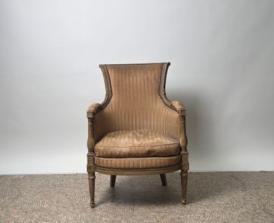 an old chair sitting on a carpeted floor in front of a white wall