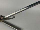 someone is using a pair of scissors to cut a piece of metal