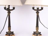 a pair of brass and wood lamps with white shades