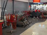 many chairs and tables in the store waiting for customers