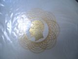 a white vase with a gold design on it