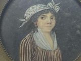 an old picture of a woman in a striped dress and a hat