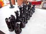 a lot of black vases on a table with a white table cloth