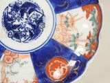 a blue and white plate with a picture of a dragon on it