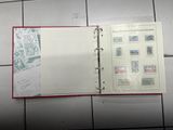 a book with stamps on it sitting on a tiled floor