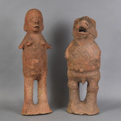 two clay figurines of a man and a woman standing next to each other