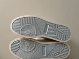 the bottom of a pair of white shoes on top of a box