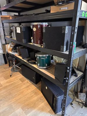 a shelf that has a lot of musical equipment on it