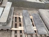 many pieces of wood sitting on the ground next to each other