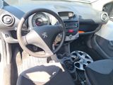 dashboard of a small car with a steering wheel and dashboard controls