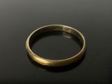 a close up of a gold ring on a black surface