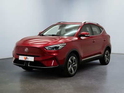 a red suv parked in a room with a white wall